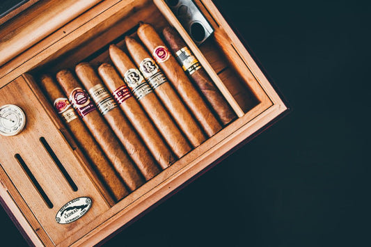 Cigars stored in a wooden humidor with hygrometer